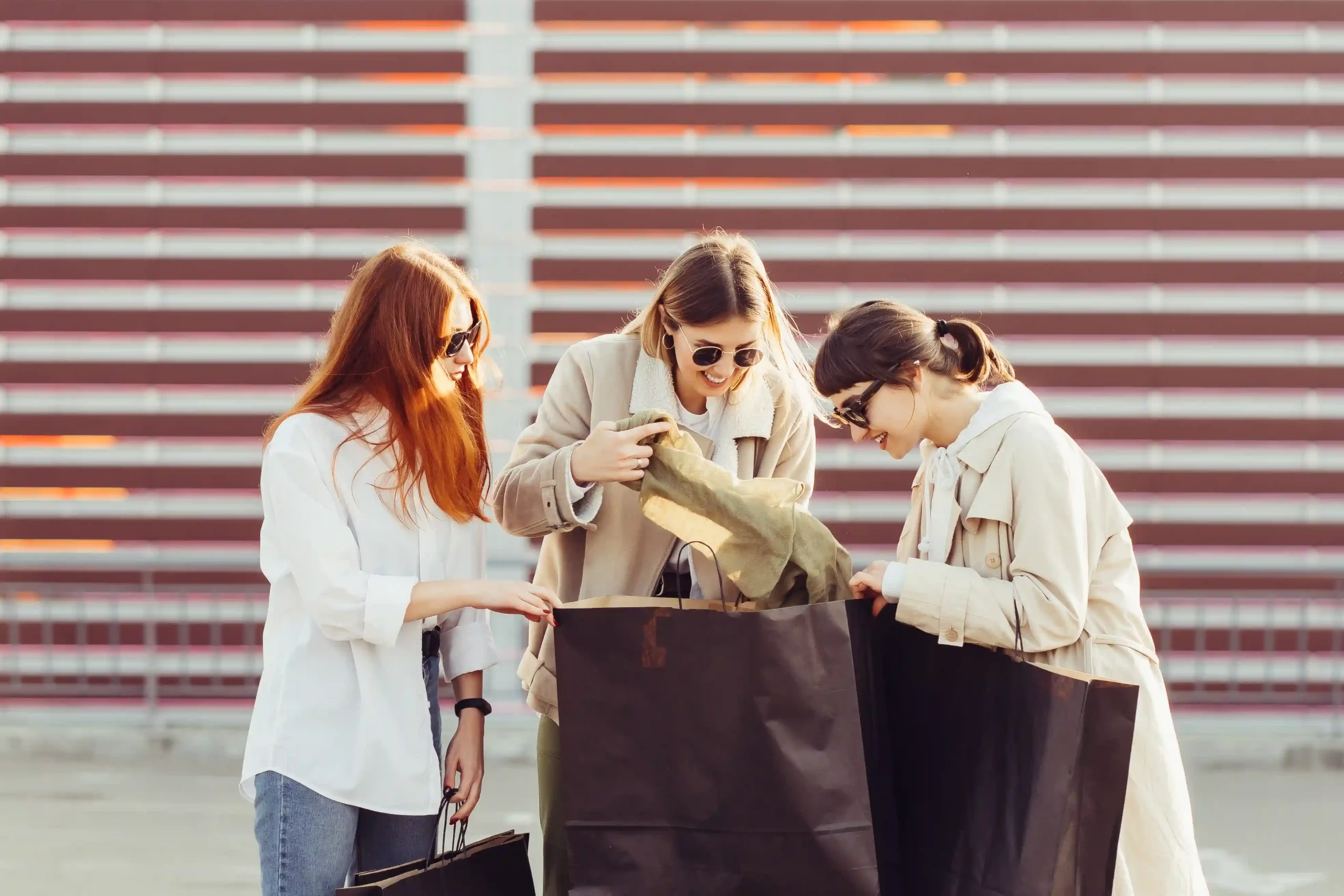 1 young-happy-women-with-shopping-bags-walking-street